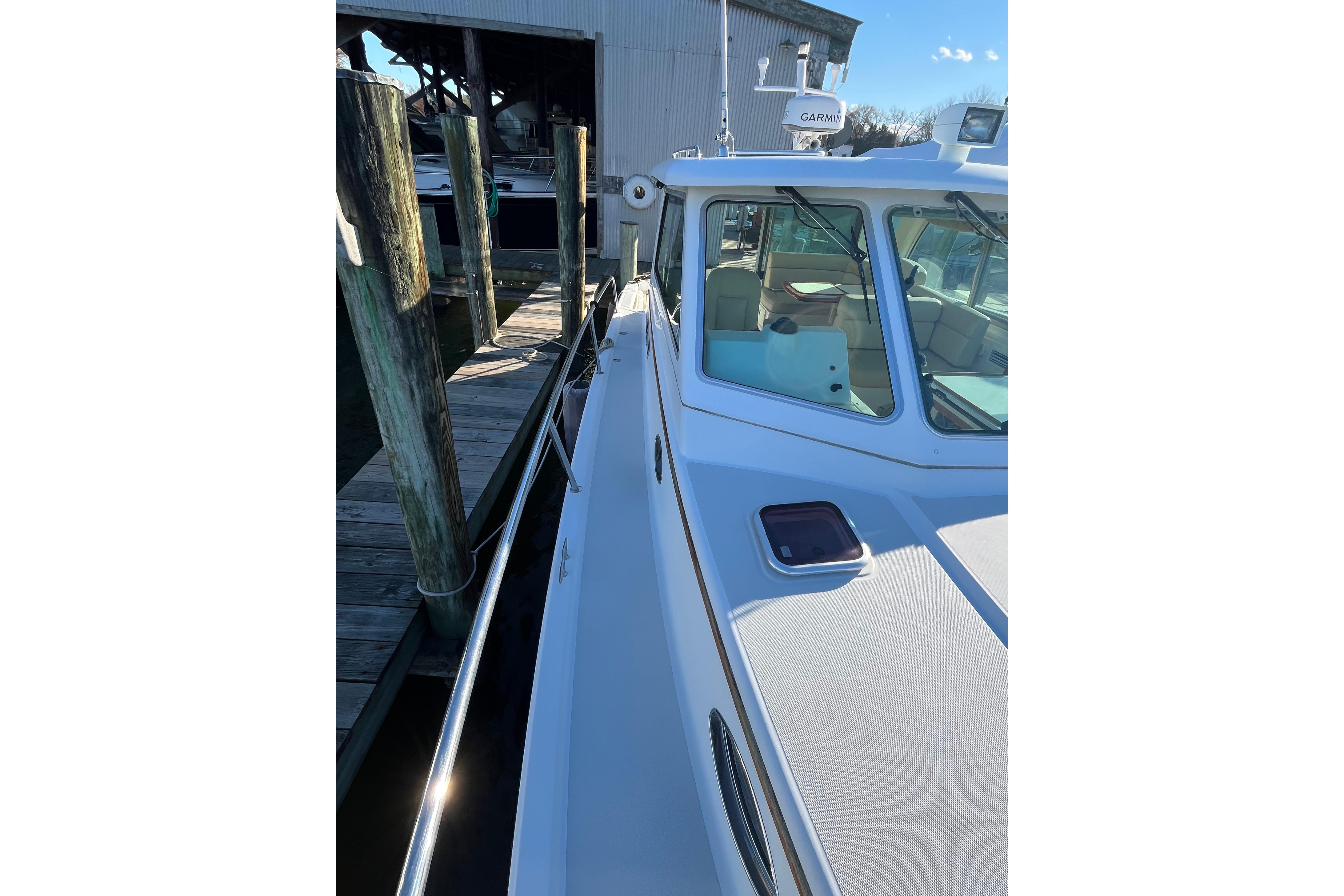 2010 Back Cove 33 Express Hardtop docked, showcasing sleek design and spacious deck.