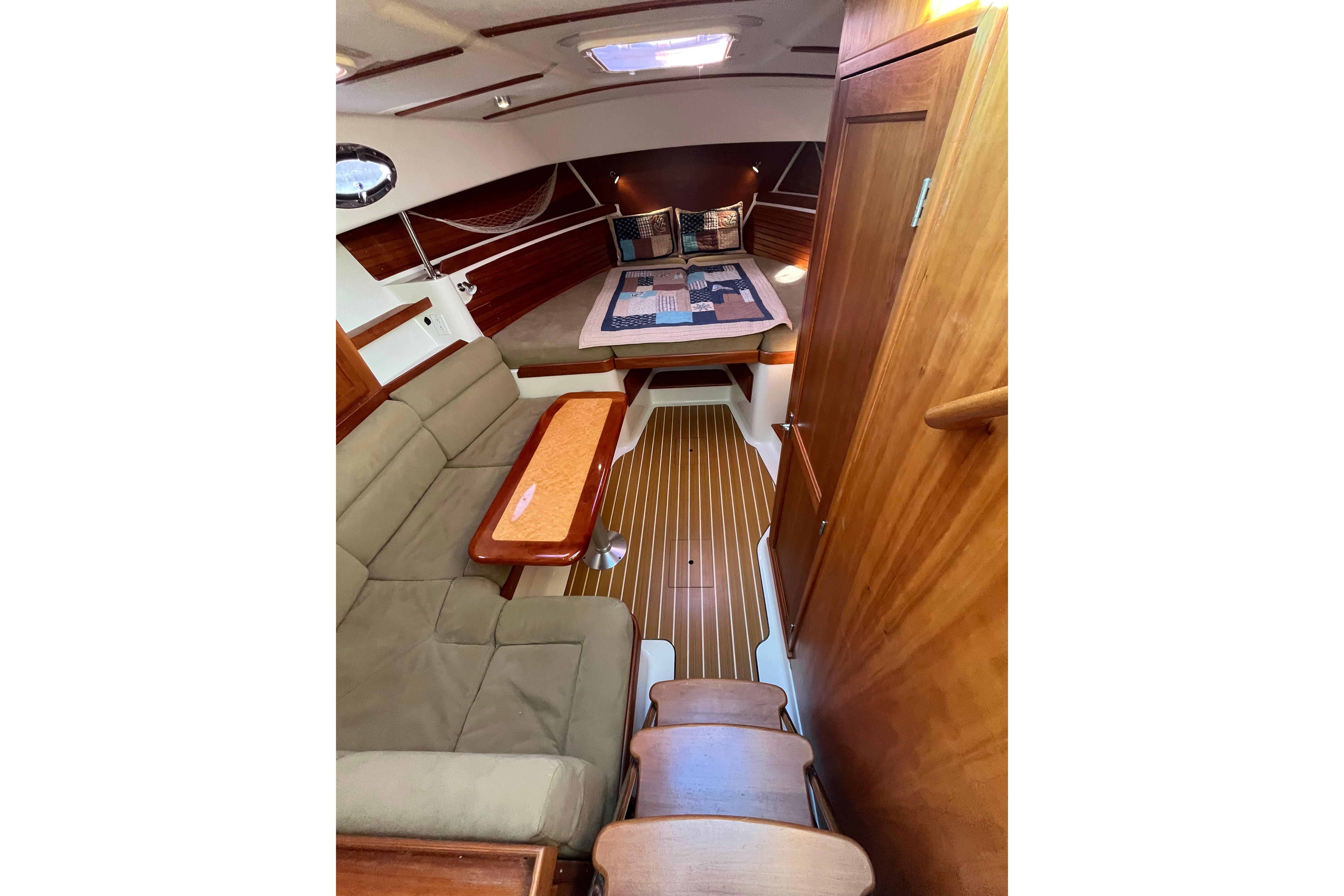2010 Back Cove 33 Express Hardtop interior with cozy seating and elegant wood finishes.