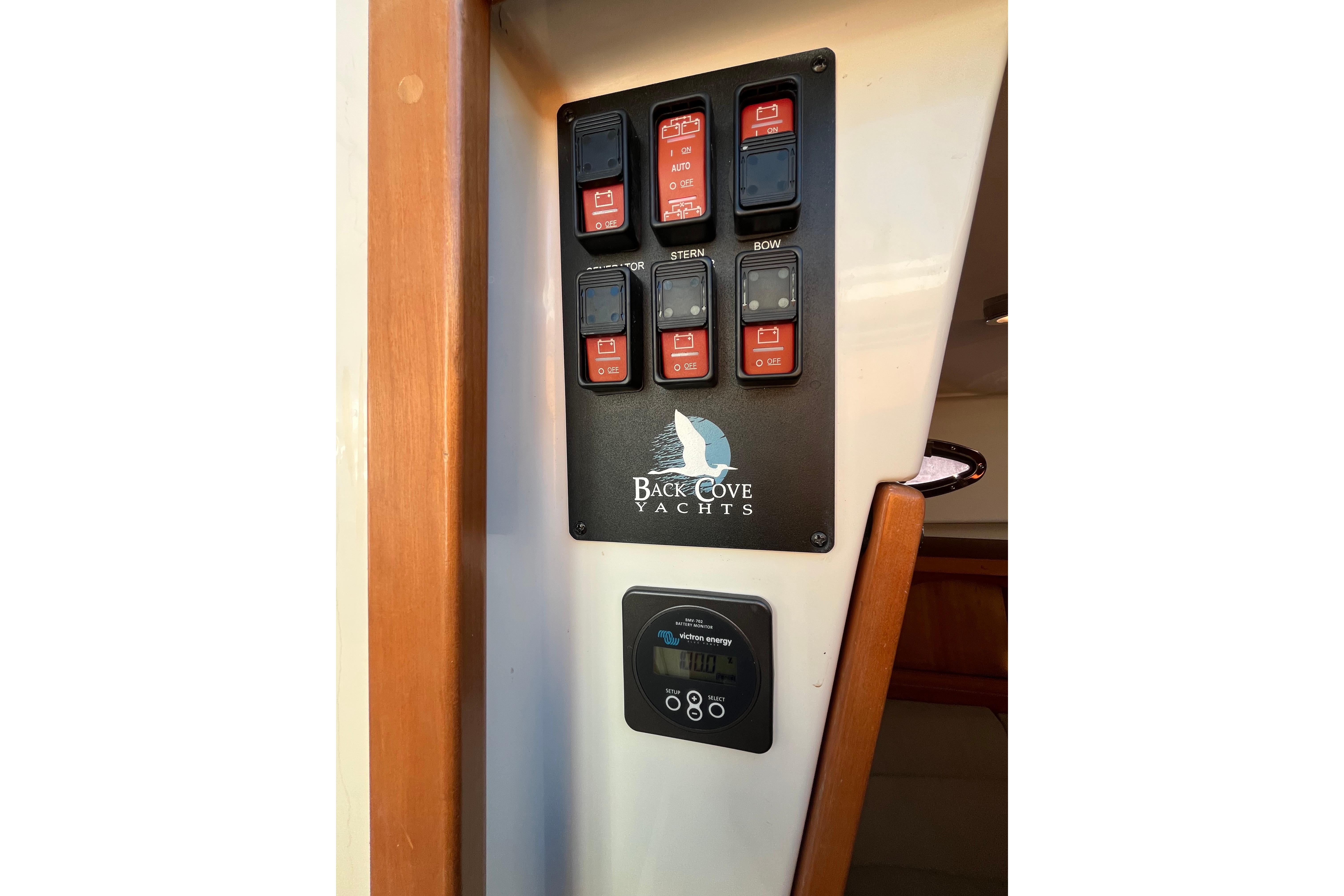Control panel of 2010 Back Cove 33 Express Hardtop yacht with switches and display.