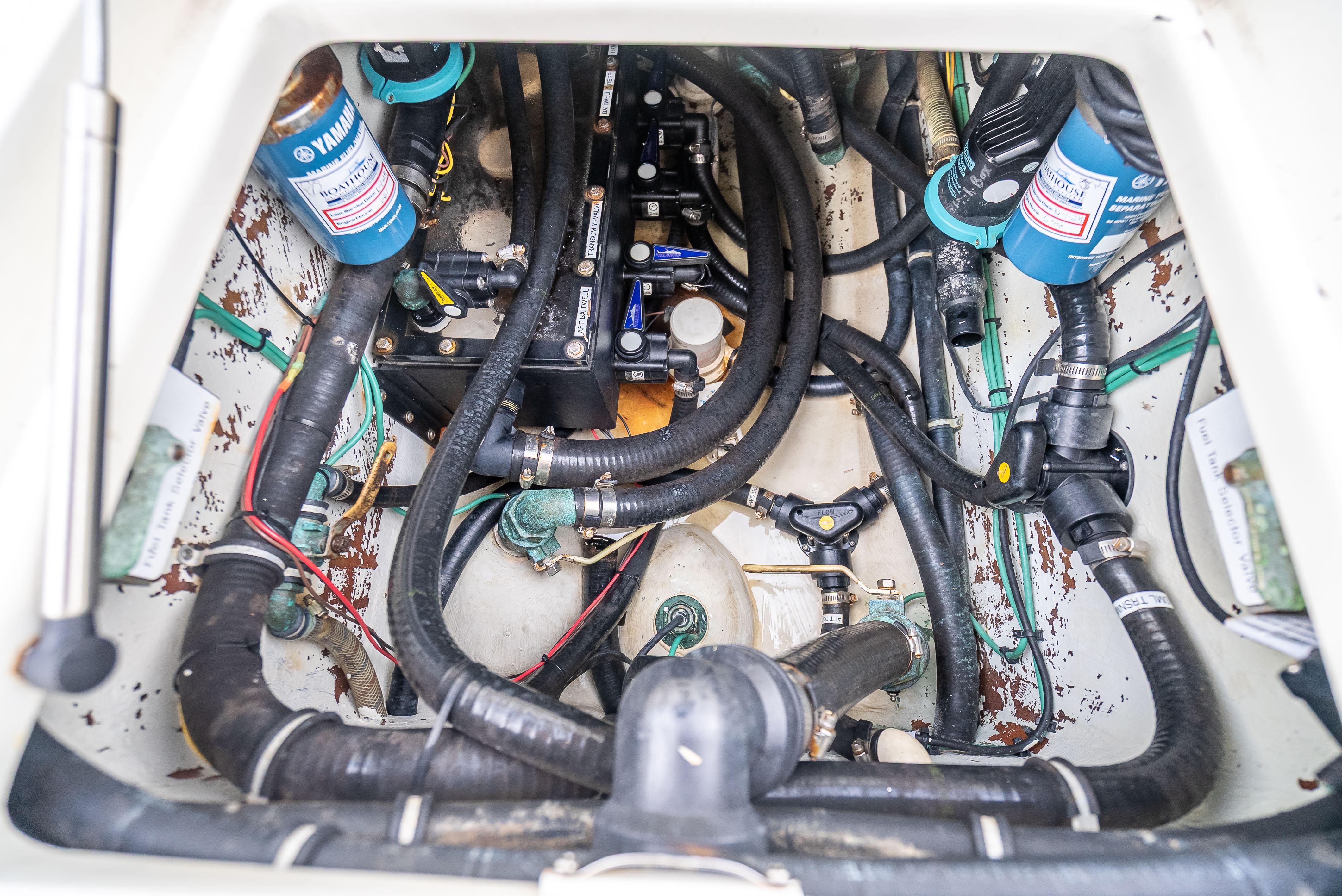 SeaVee-34 2014 -FL-US-Engine compartment of a 2014 SeaVee 34 boat, featuring Yamaha components and various hoses.-9825396 | Thumbnail