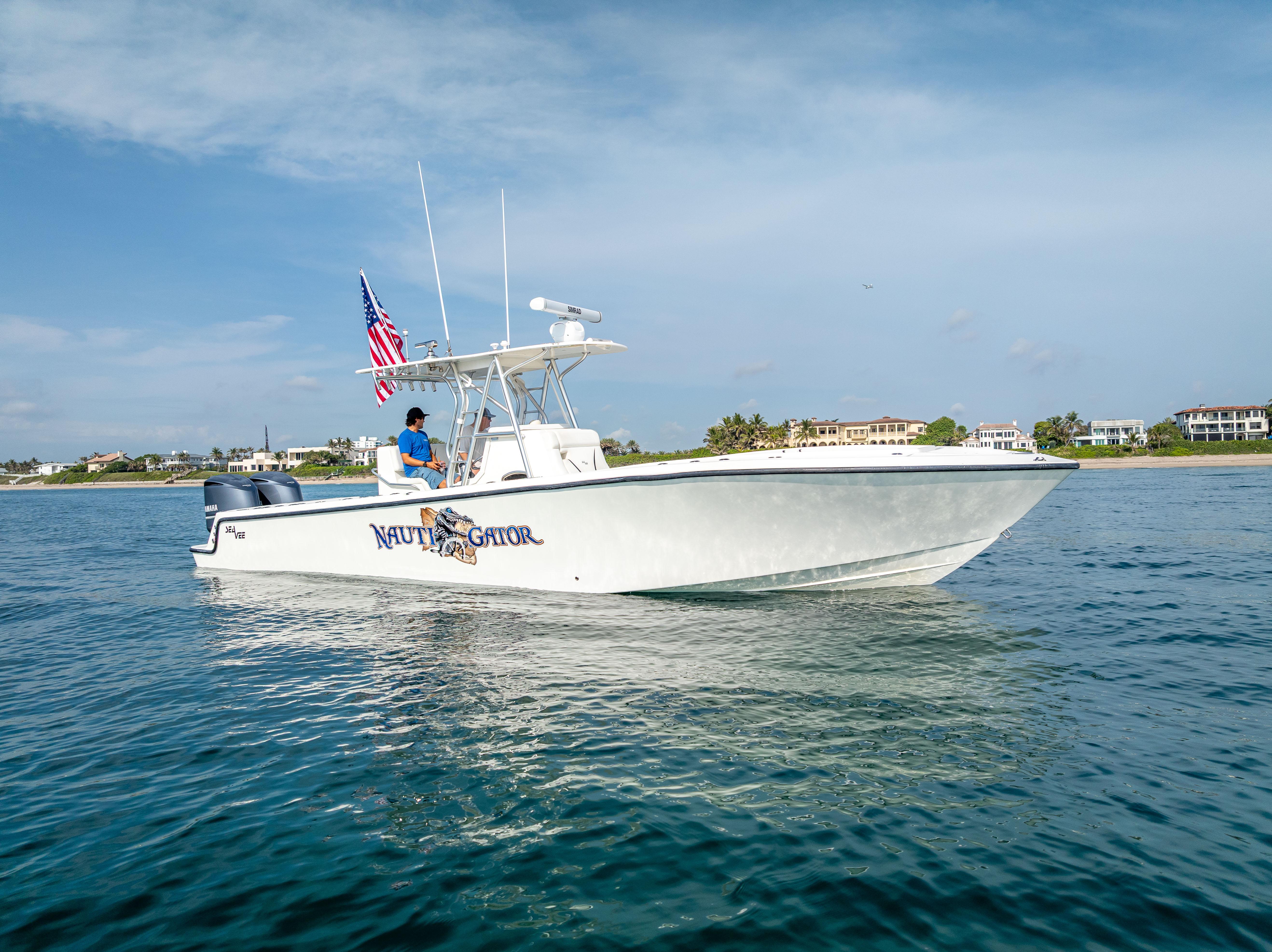 SeaVee-34 2014 -FL-US-2014 SeaVee 34 boat on water, American flag, clear sky, coastal background.-9825396