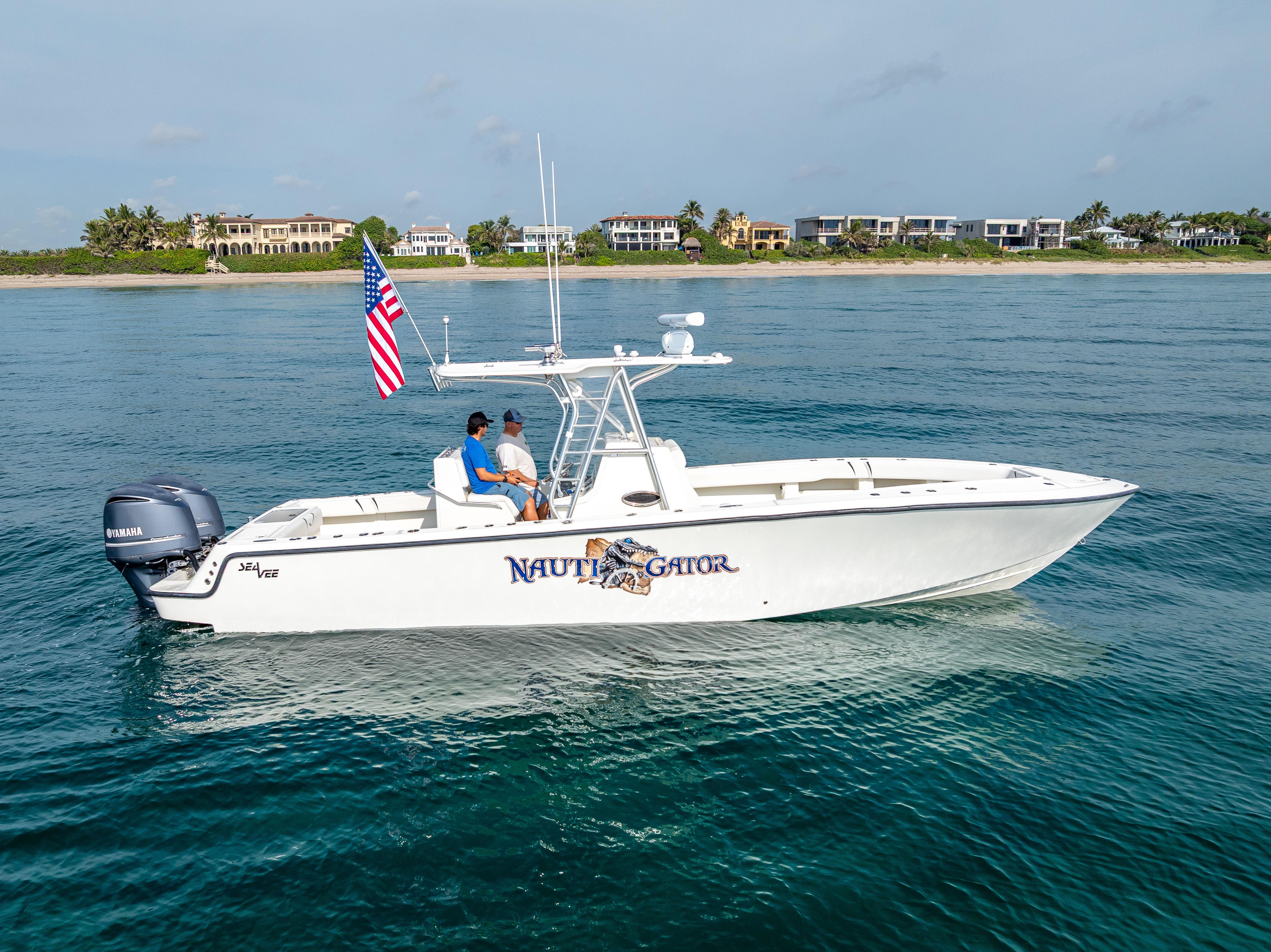 SeaVee-34 2014 -FL-US-2014 SeaVee 34 boat on water, American flag, coastal homes in background.-9825396 | Thumbnail
