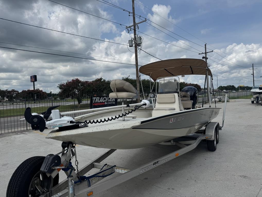2013 Xpress Hyper-Lift Bay Series H22B boat on trailer, parked outdoors.