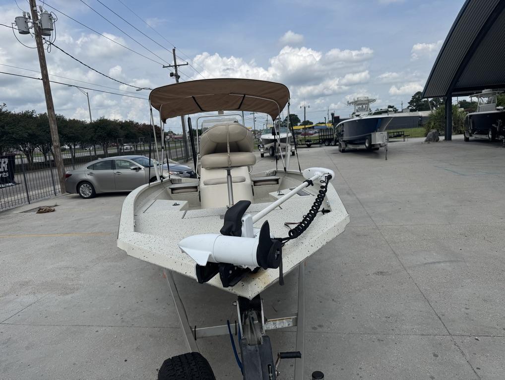 2013 Xpress Hyper-Lift Bay Series H22B boat with canopy in a parking lot.