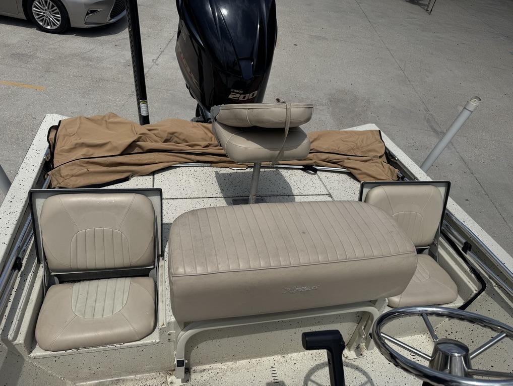2013 Xpress Hyper-Lift Bay Series H22B boat interior with seating and steering wheel.