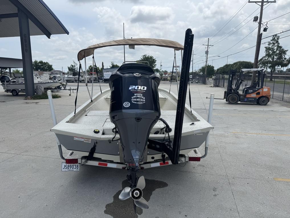 2013 Xpress Hyper-Lift Bay Series H22B boat with Yamaha 200 engine, parked outdoors.