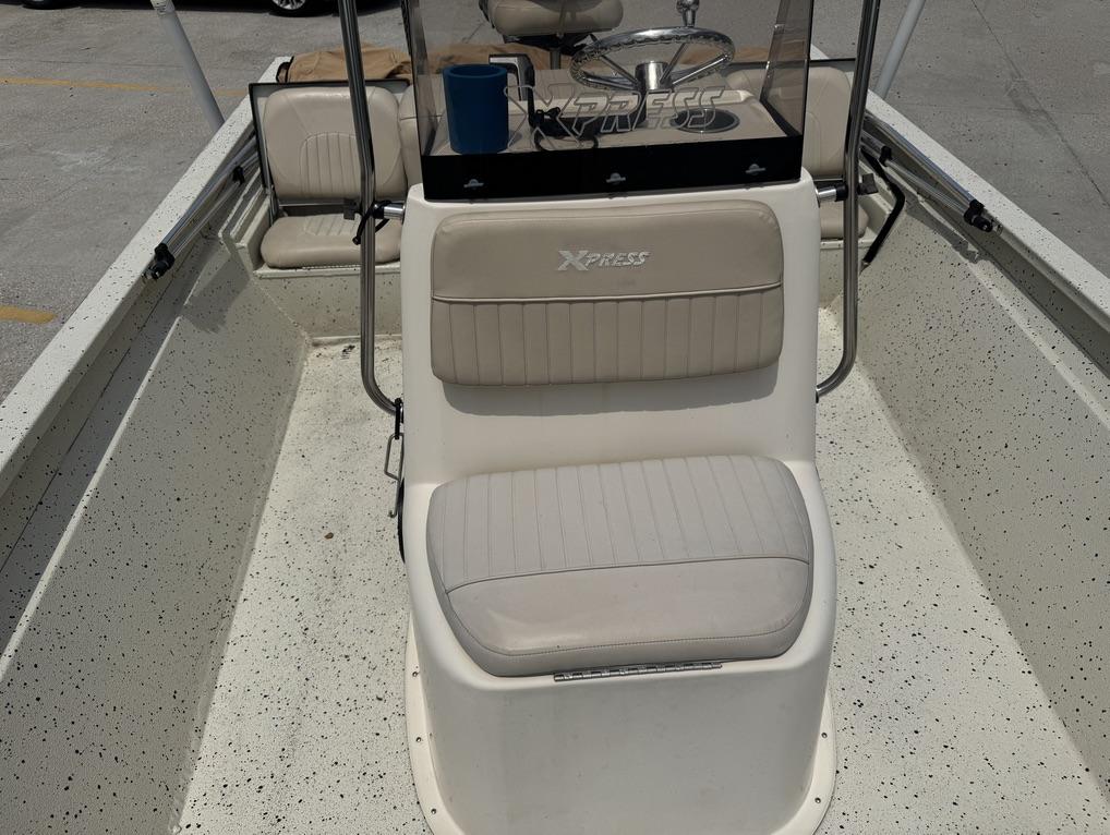 2013 Xpress Hyper-Lift Bay Series H22B boat interior with seating and steering console.