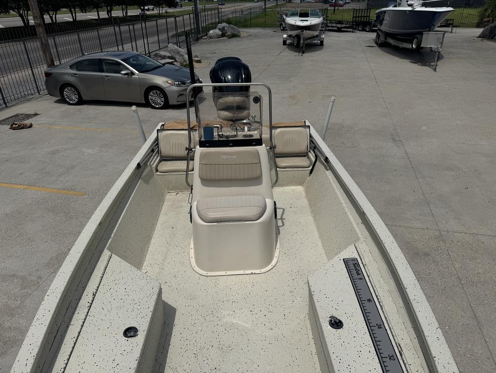 2013 Xpress Hyper-Lift Bay Series H22B boat in a parking lot, interior view.