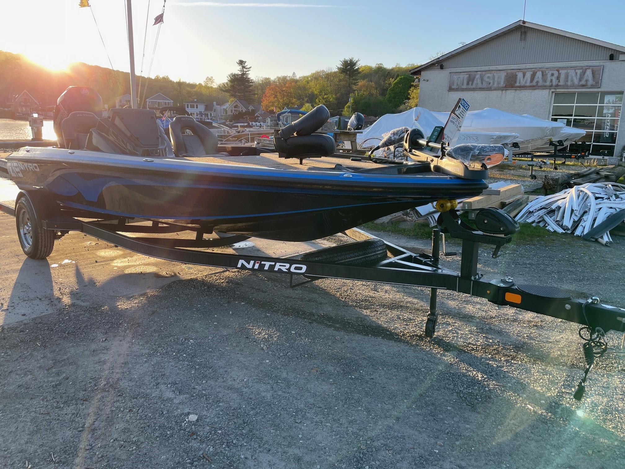 2024 Nitro Z19 boat on trailer at marina during sunset.