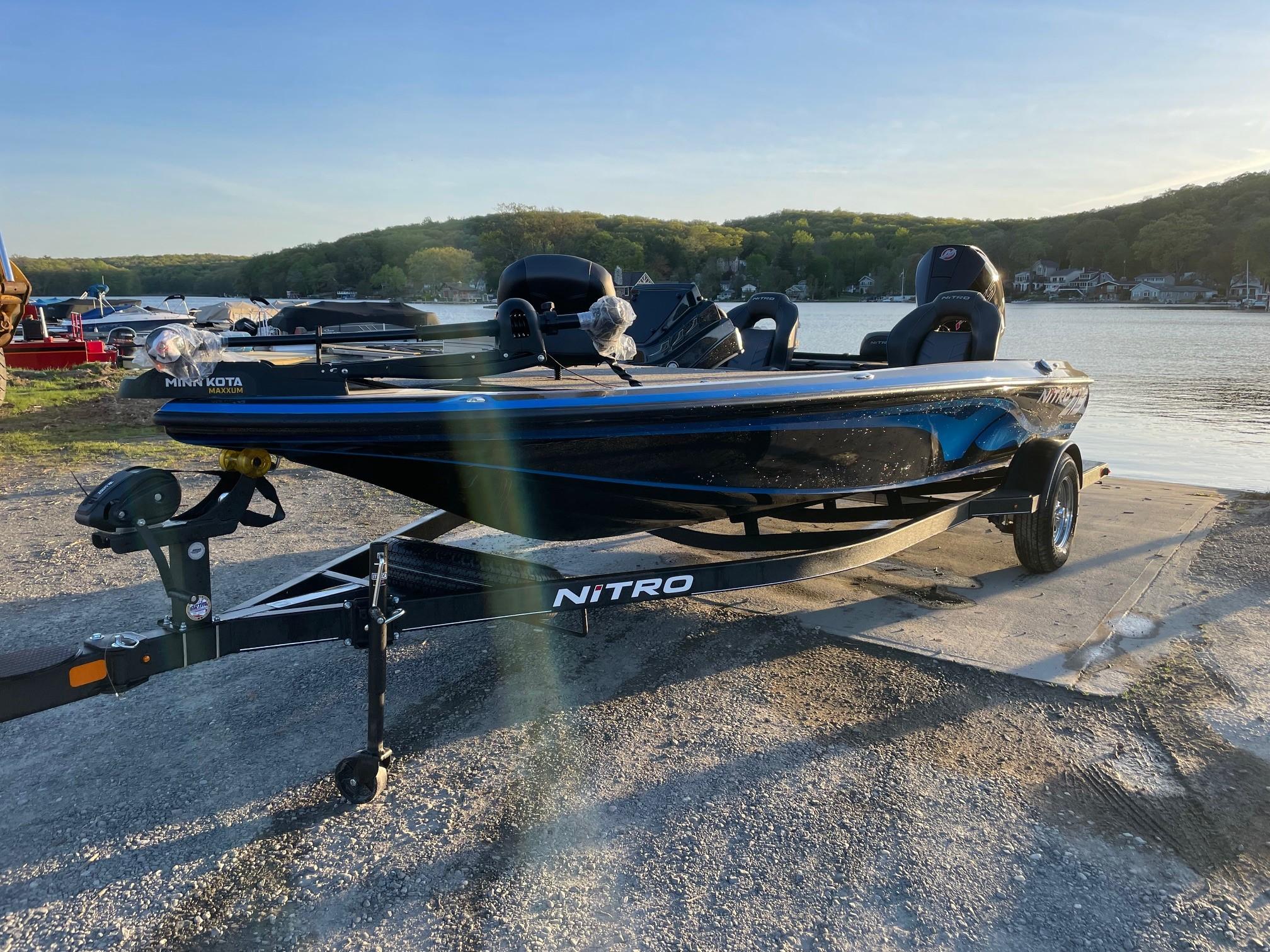 2024 Nitro Z19 boat parked by a lake.
