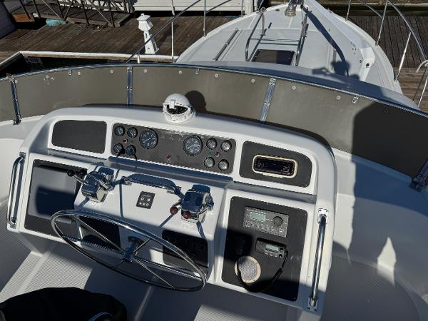 Cockpit view of 1991 Ocean Alexander 46 yacht with steering wheel and control panel.