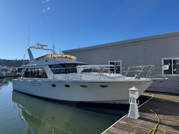 1991 Ocean Alexander 46 yacht docked at marina under clear blue sky.