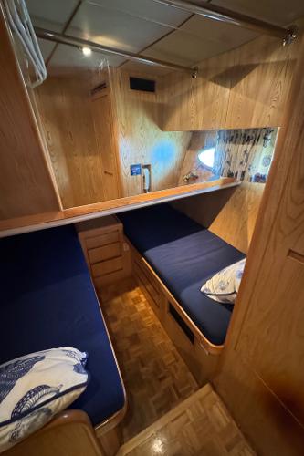 Cozy cabin interior of 1991 Ocean Alexander 46 yacht with twin beds and wooden finish.