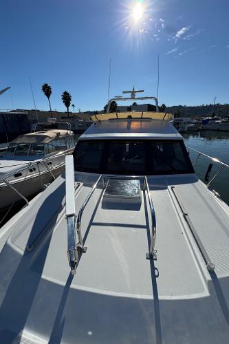 1991 Ocean Alexander 46 yacht docked under clear blue sky.