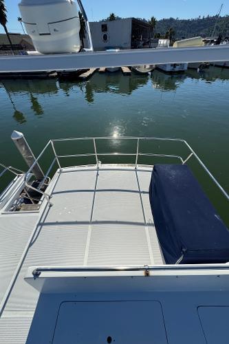 1991 Ocean Alexander 46 yacht deck overlooking calm marina waters.