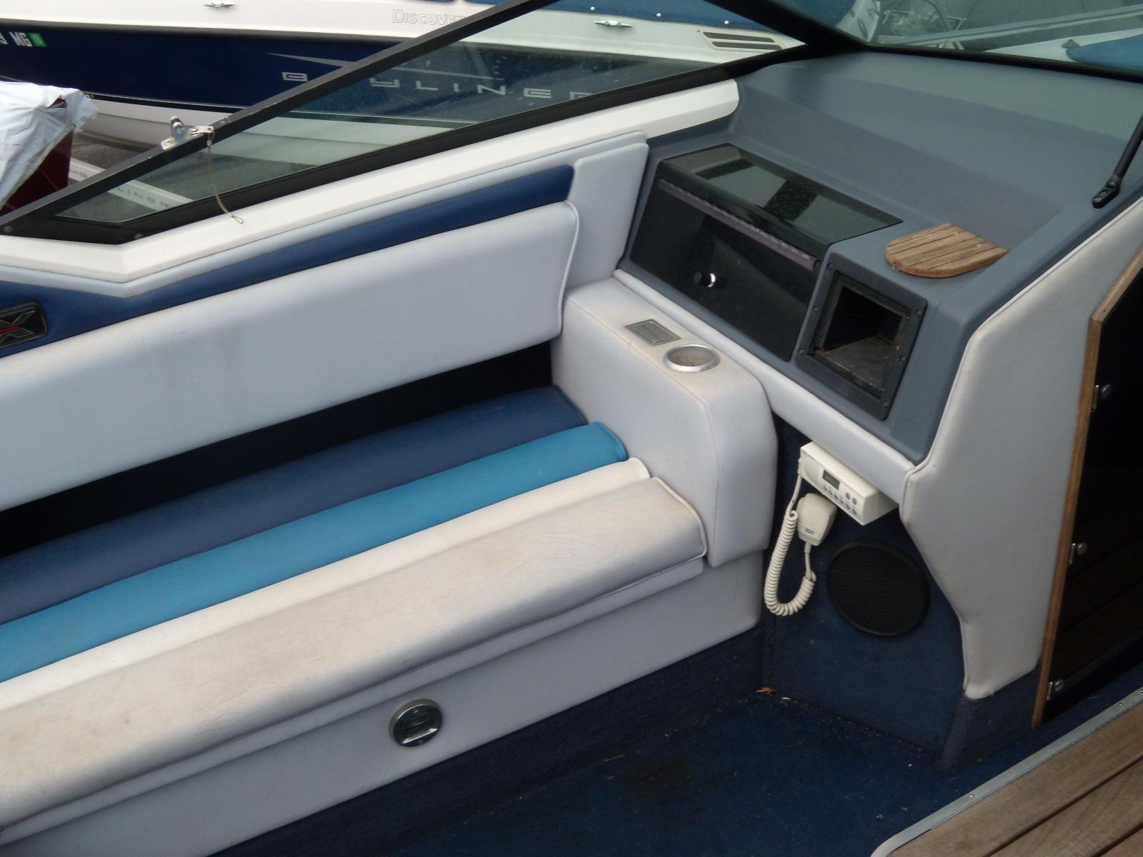 1989 Chaparral 2300 SX Sport boat interior with blue and white seating and dashboard.