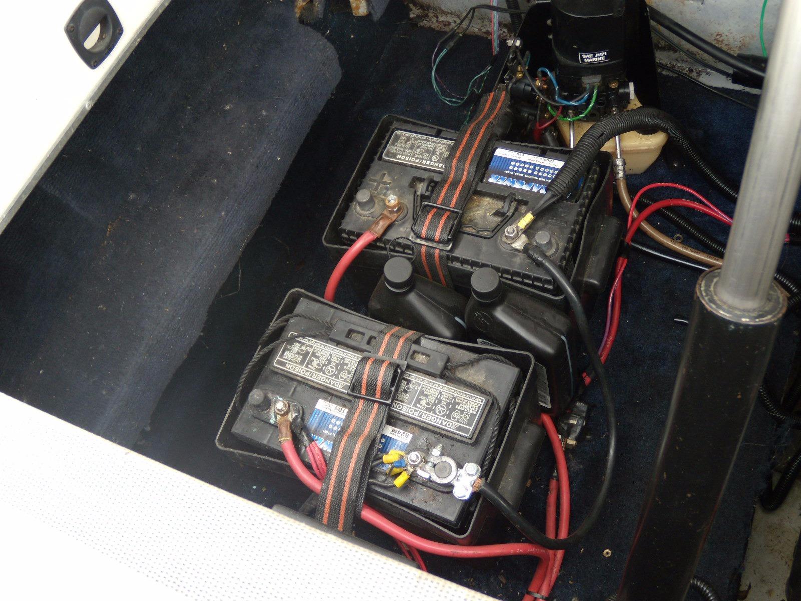 Batteries in 1989 Chaparral 2300 SX Sport boat, secured with straps and connected with cables.