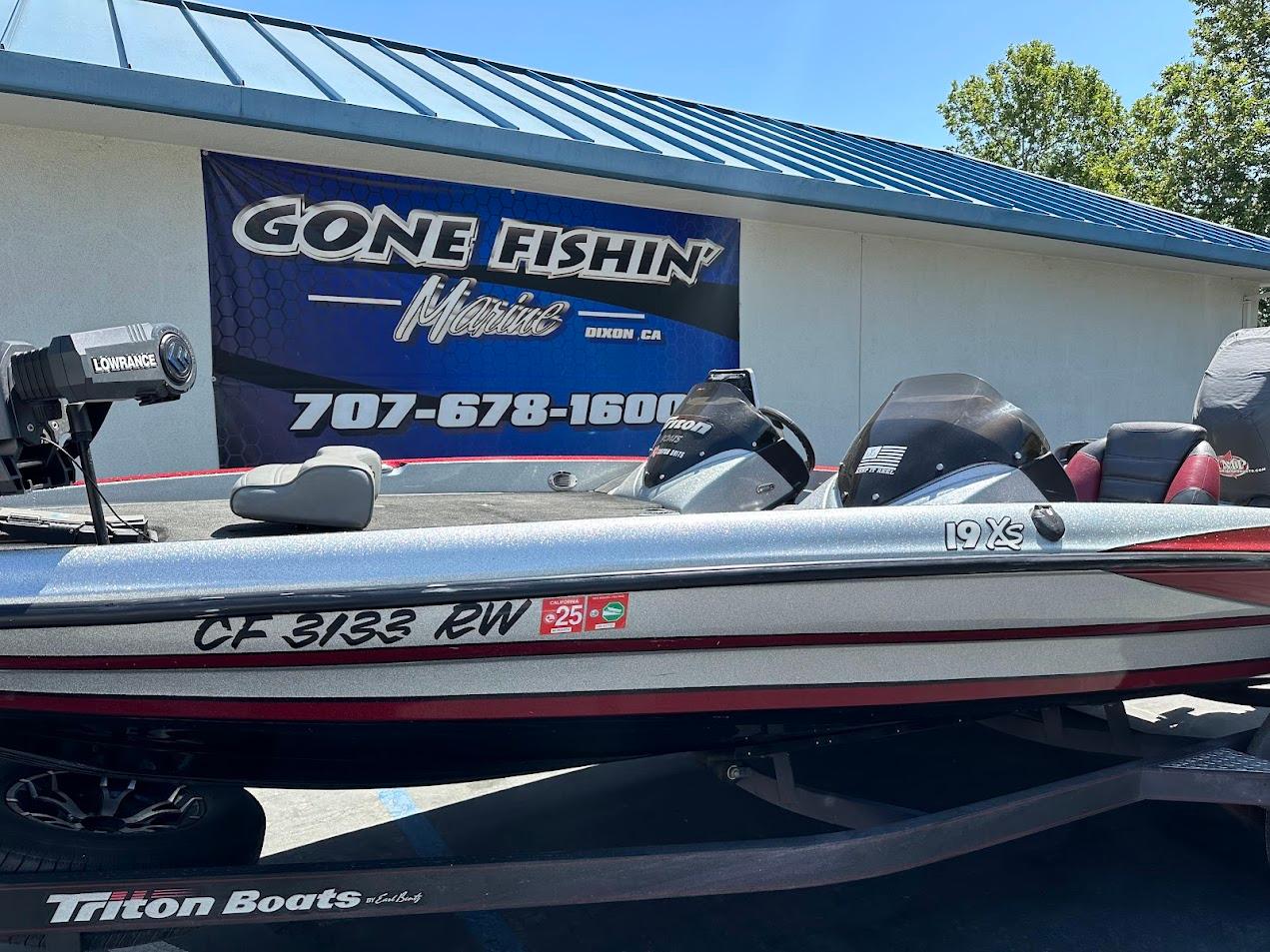 2013 Triton 19XS boat parked at Gone Fishin' Marine dealership.