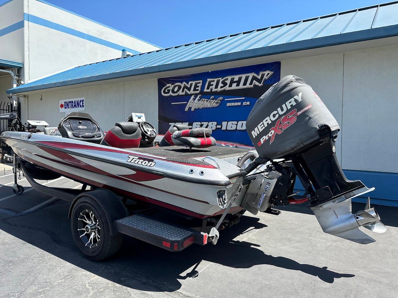 2013 Triton 19XS boat with Mercury Pro XS engine at dealership.