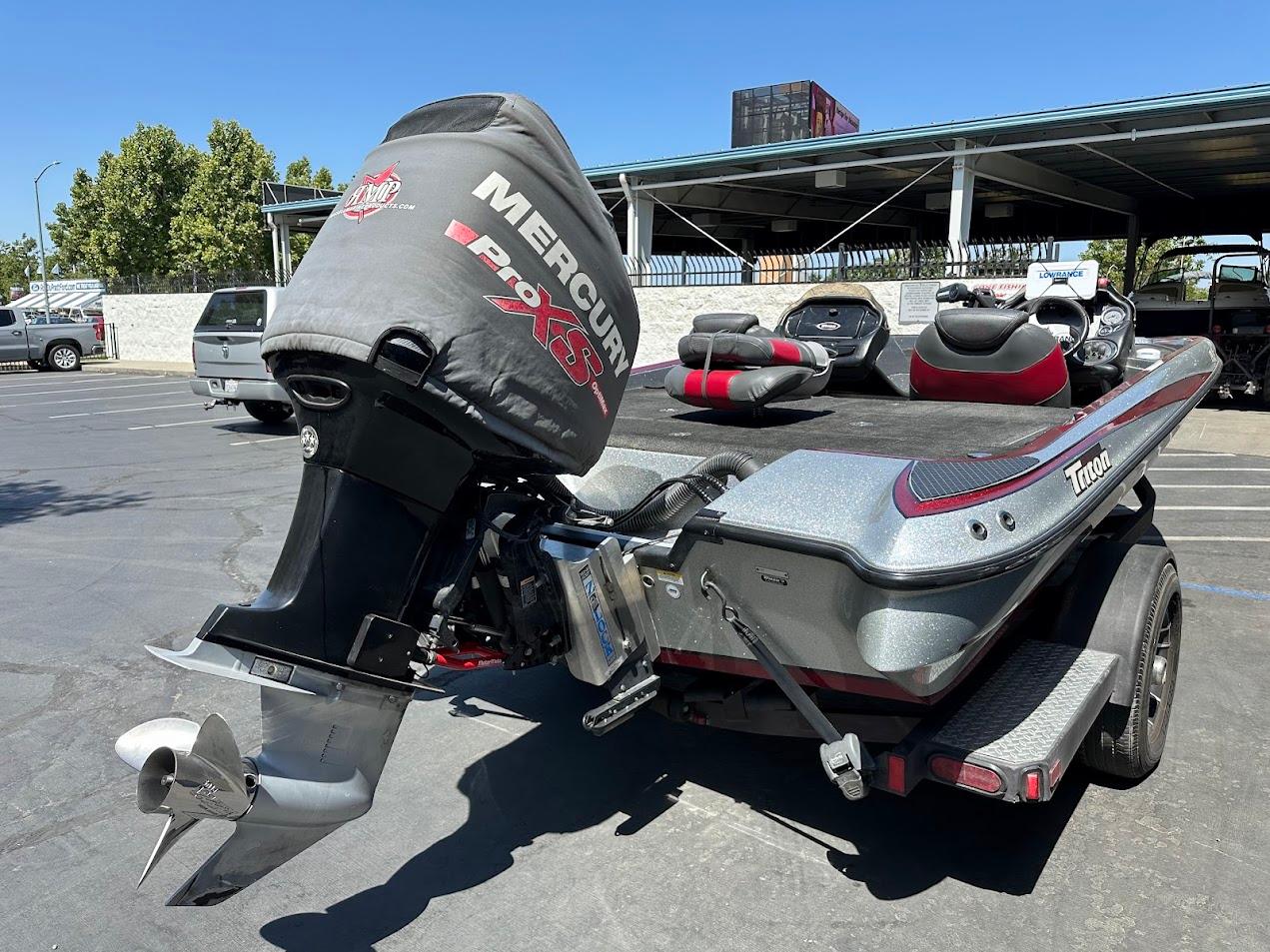 2013 Triton 19XS boat with Mercury Pro XS engine in parking lot.