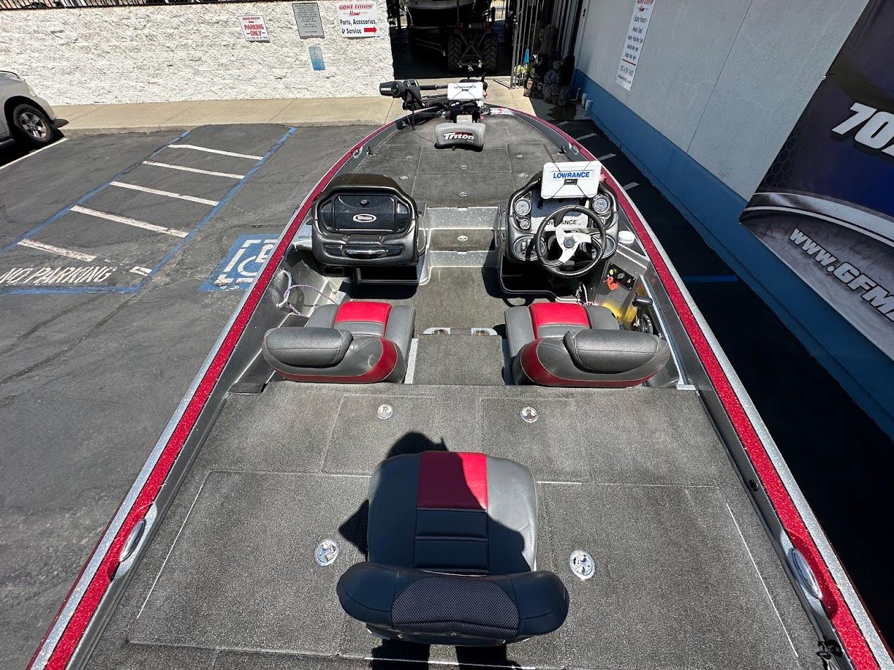 2013 Triton 19XS boat interior with seating and steering wheel, parked in a lot.
