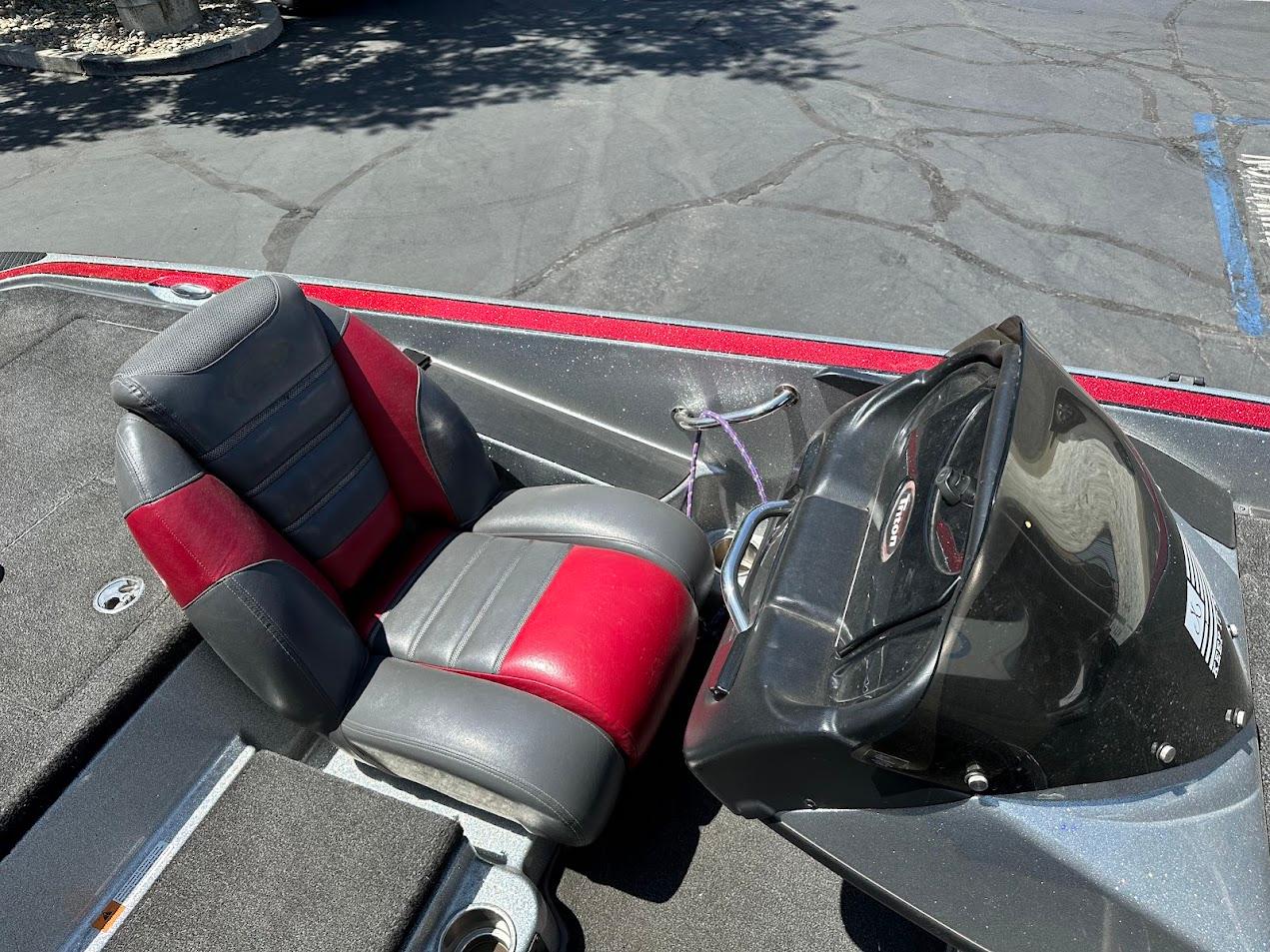 2013 Triton 19XS boat interior with red and gray seats and steering console.