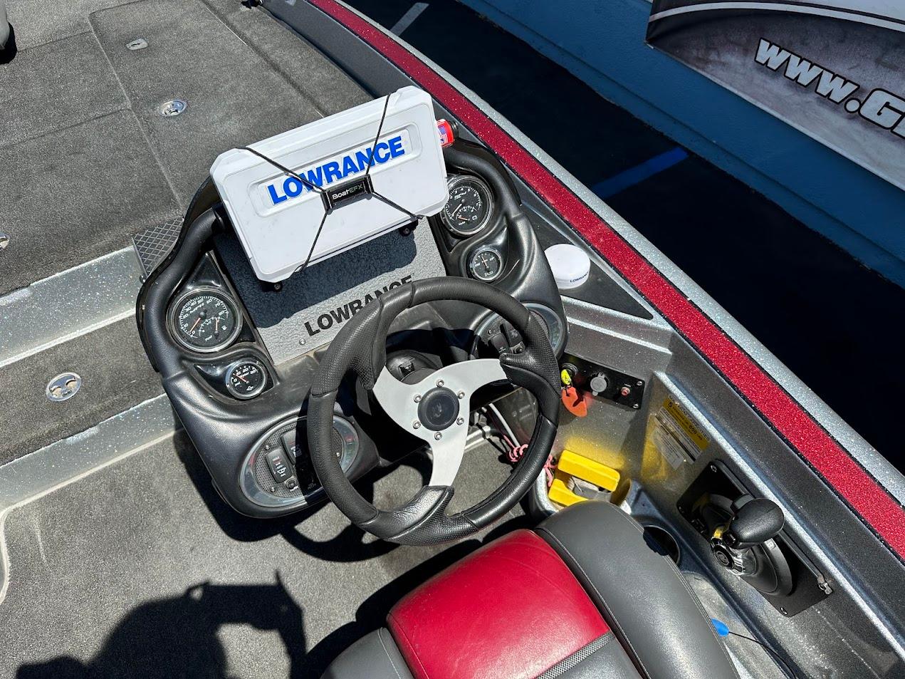 2013 Triton 19XS boat dashboard with Lowrance navigation system and steering wheel.