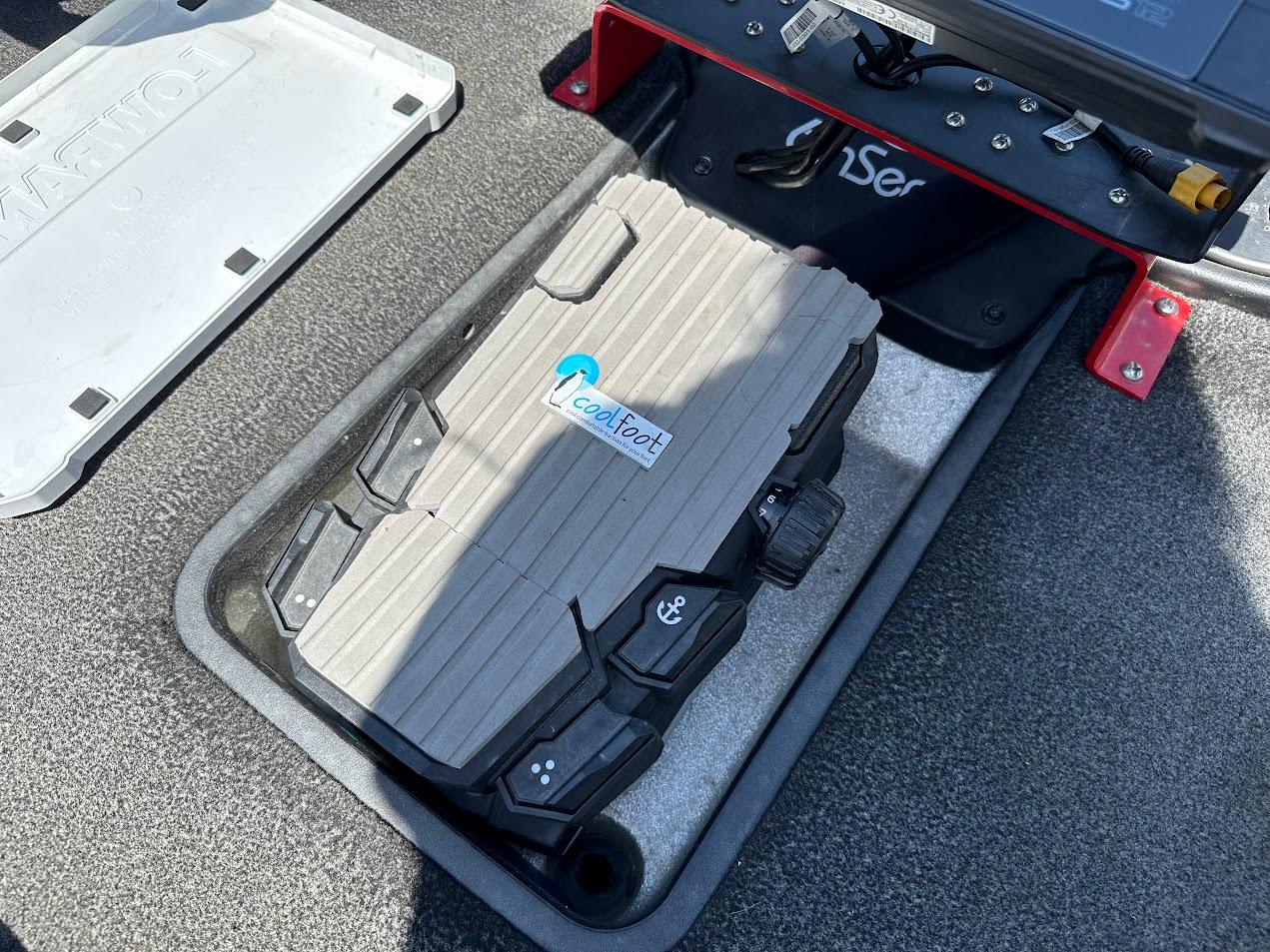 2013 Triton 19XS boat compartment with a SeaDek pad and storage area.