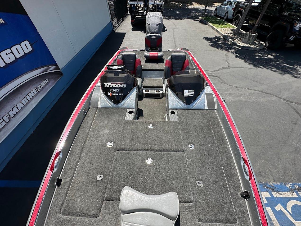 2013 Triton 19XS boat with spacious deck and seating, parked outdoors.