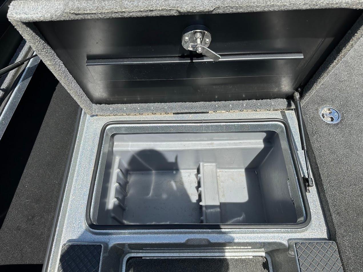 Open storage compartment in 2013 Triton 19XS boat, featuring a secure latch mechanism.