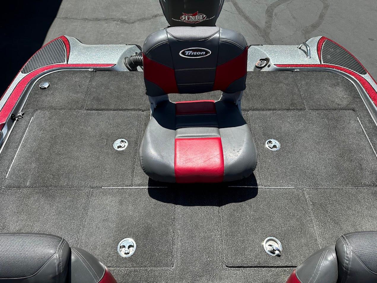 2013 Triton 19XS boat interior with red and gray seating and carpeted deck.