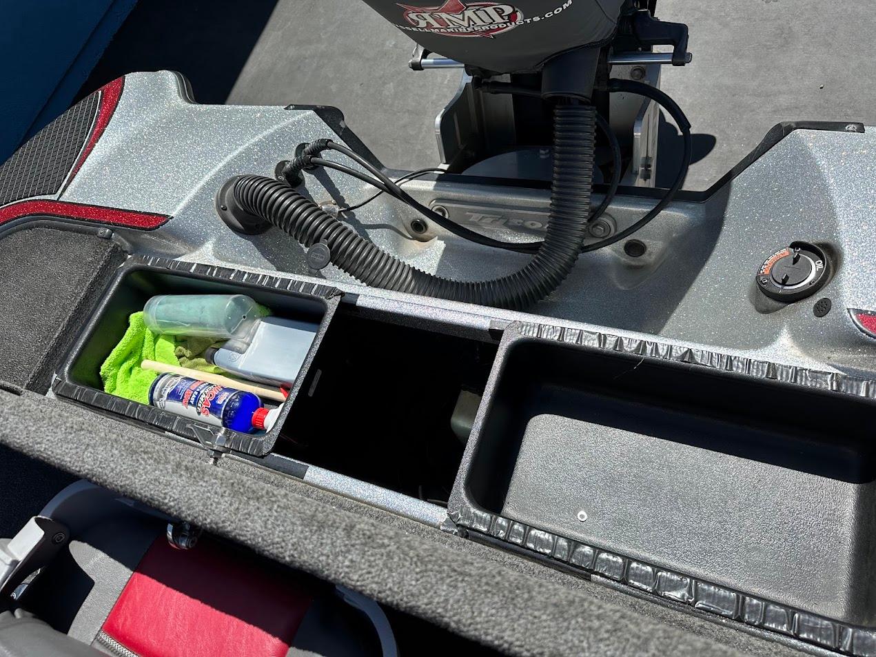 2013 Triton 19XS boat storage compartments with fishing gear and accessories.
