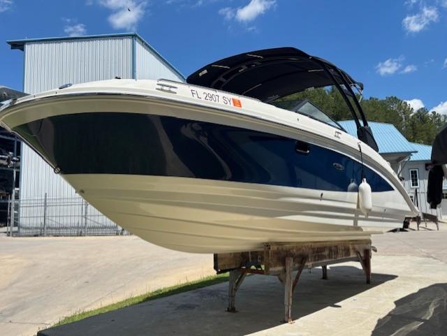 2021 Sea Ray SDX 270 Outboard boat on display under a clear blue sky.