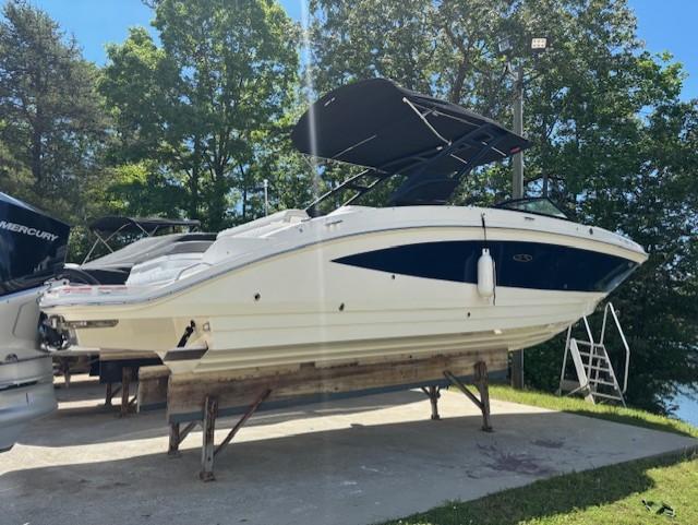 2021 Sea Ray SDX 270 Outboard boat on display, surrounded by trees.
