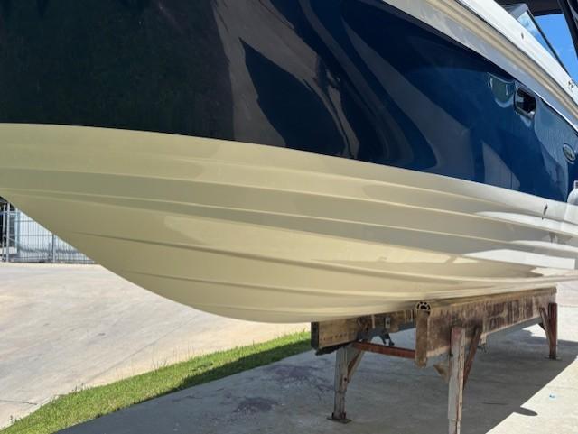 2021 Sea Ray SDX 270 Outboard boat hull on display stand.