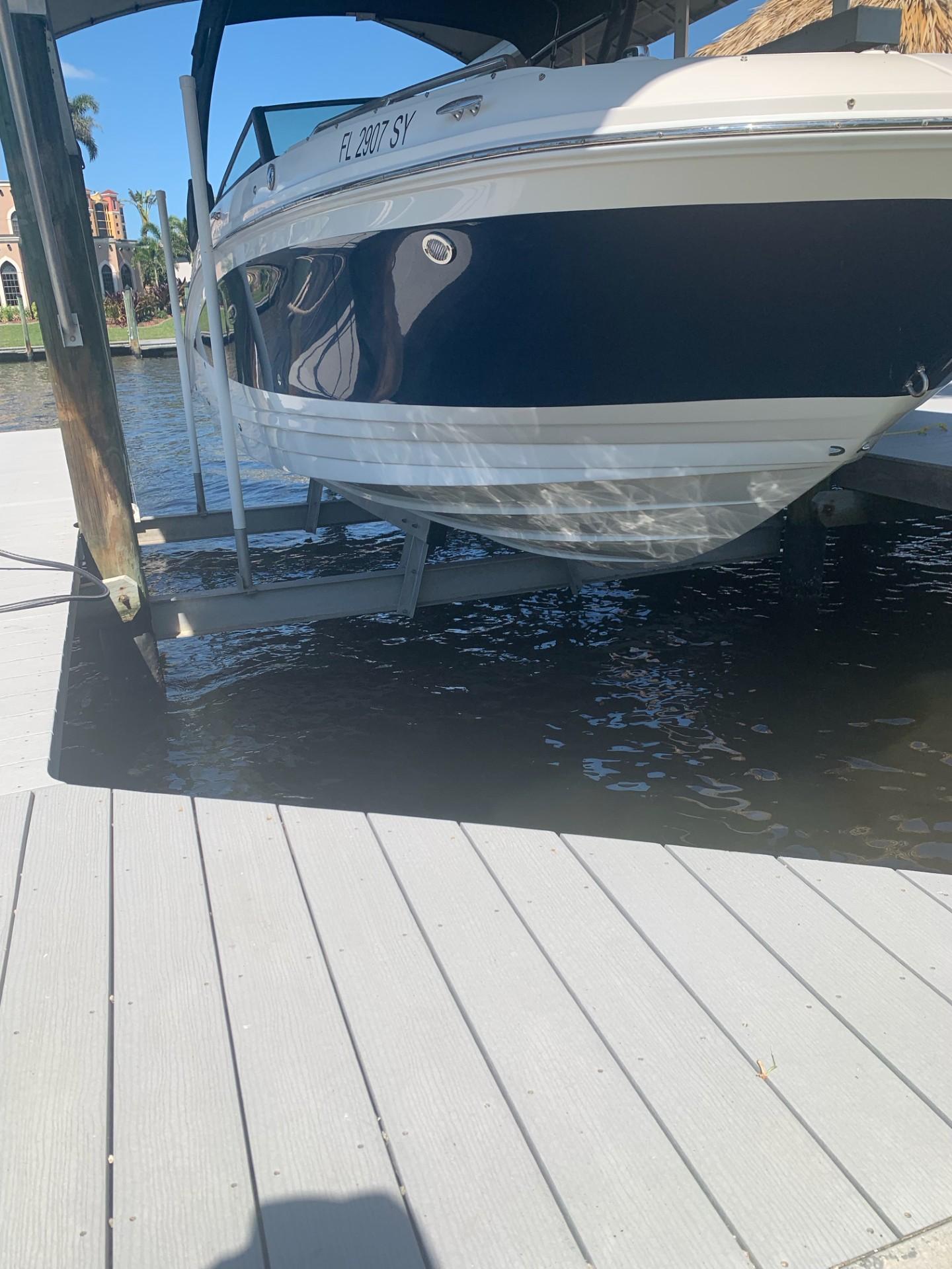 2021 Sea Ray SDX 270 Outboard boat docked on a sunny day.