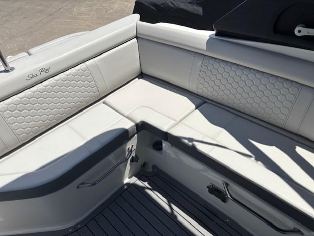 2021 Sea Ray SDX 270 Outboard boat interior with white cushioned seating and hexagonal pattern.