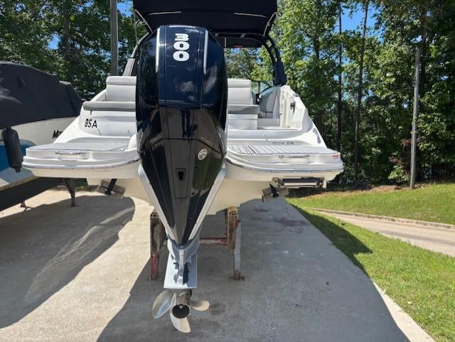 2021 Sea Ray SDX 270 Outboard boat with powerful engine, parked outdoors.