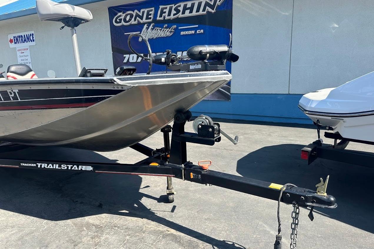 2001 Bass Tracker Pro Team 175 boat on trailer at dealership.