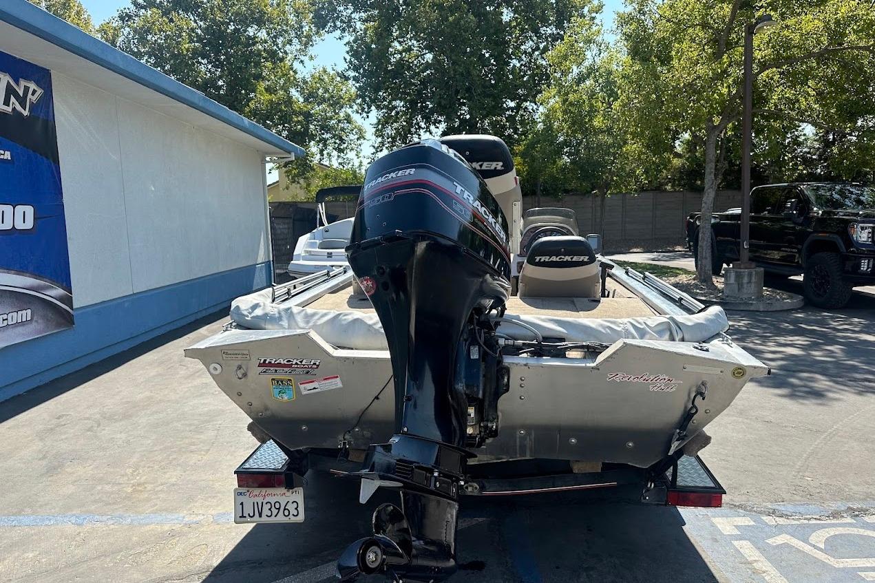 2001 Bass Tracker Pro Team 175 boat with outboard motor in parking lot.