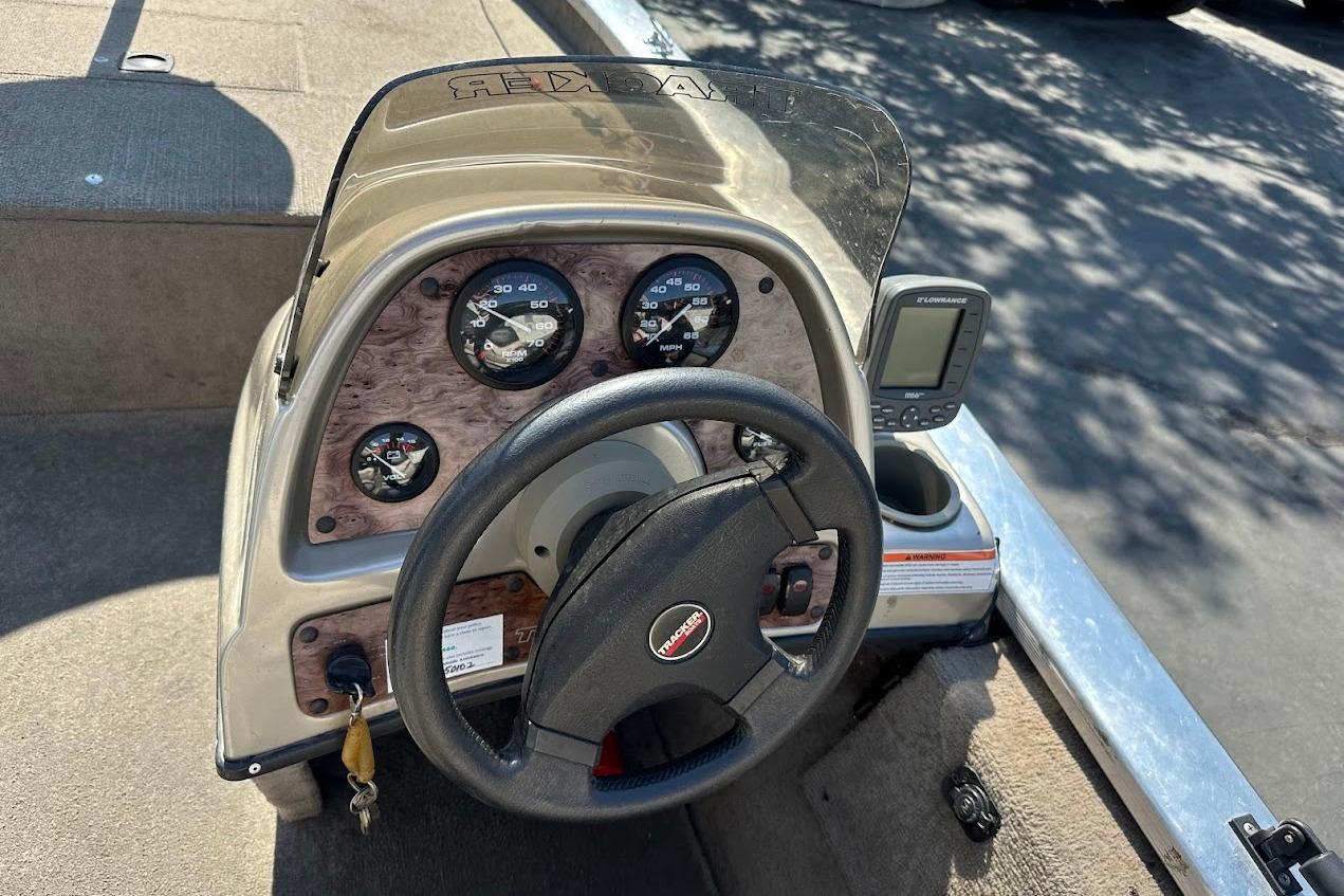 2001 Bass Tracker Pro Team 175 dashboard with steering wheel and gauges.
