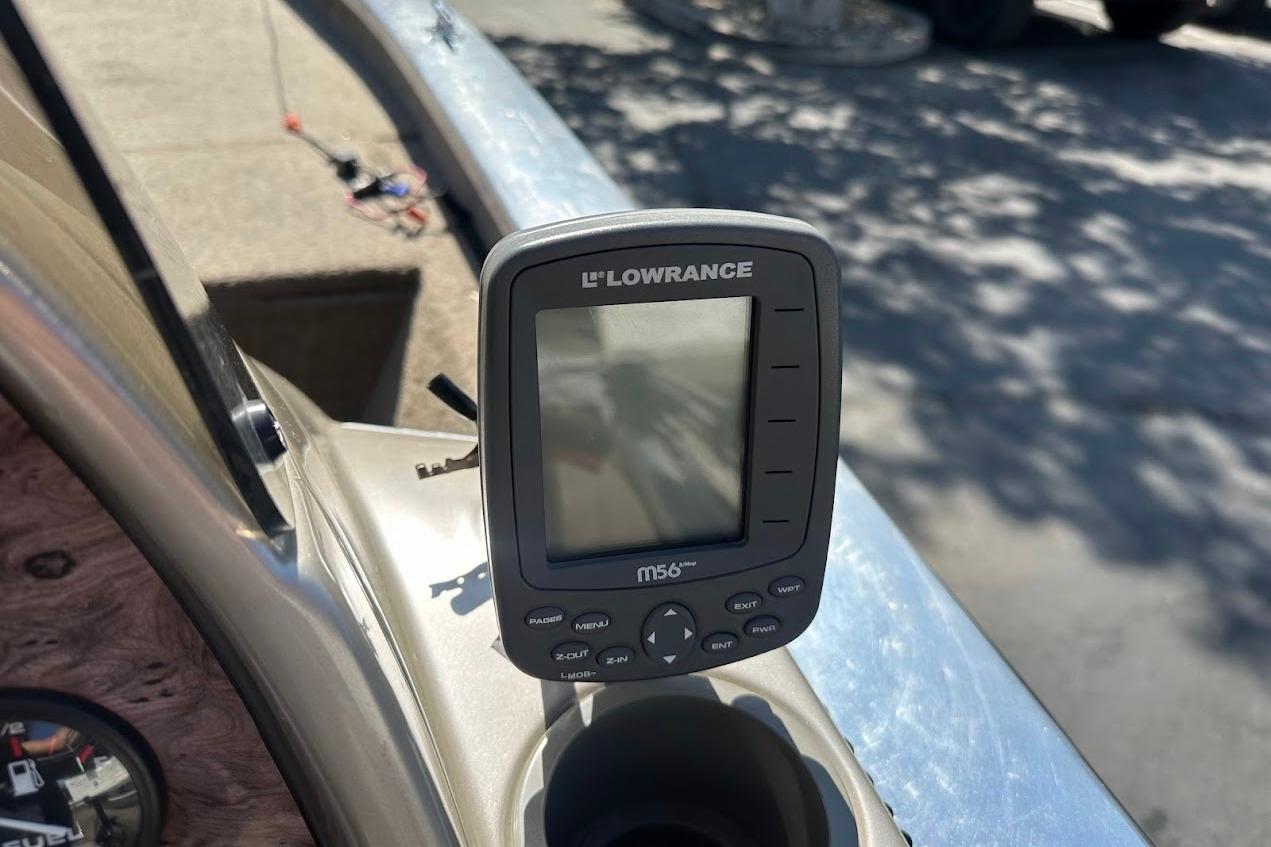 Lowrance fish finder on 2001 Bass Tracker Pro Team 175 boat dashboard.