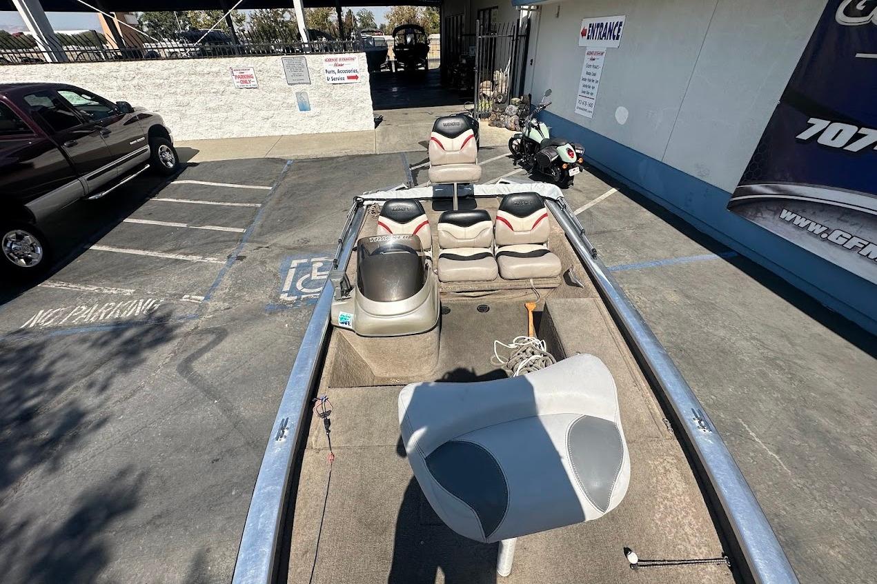 2001 Bass Tracker Pro Team 175 boat in parking lot, featuring seating and equipment.