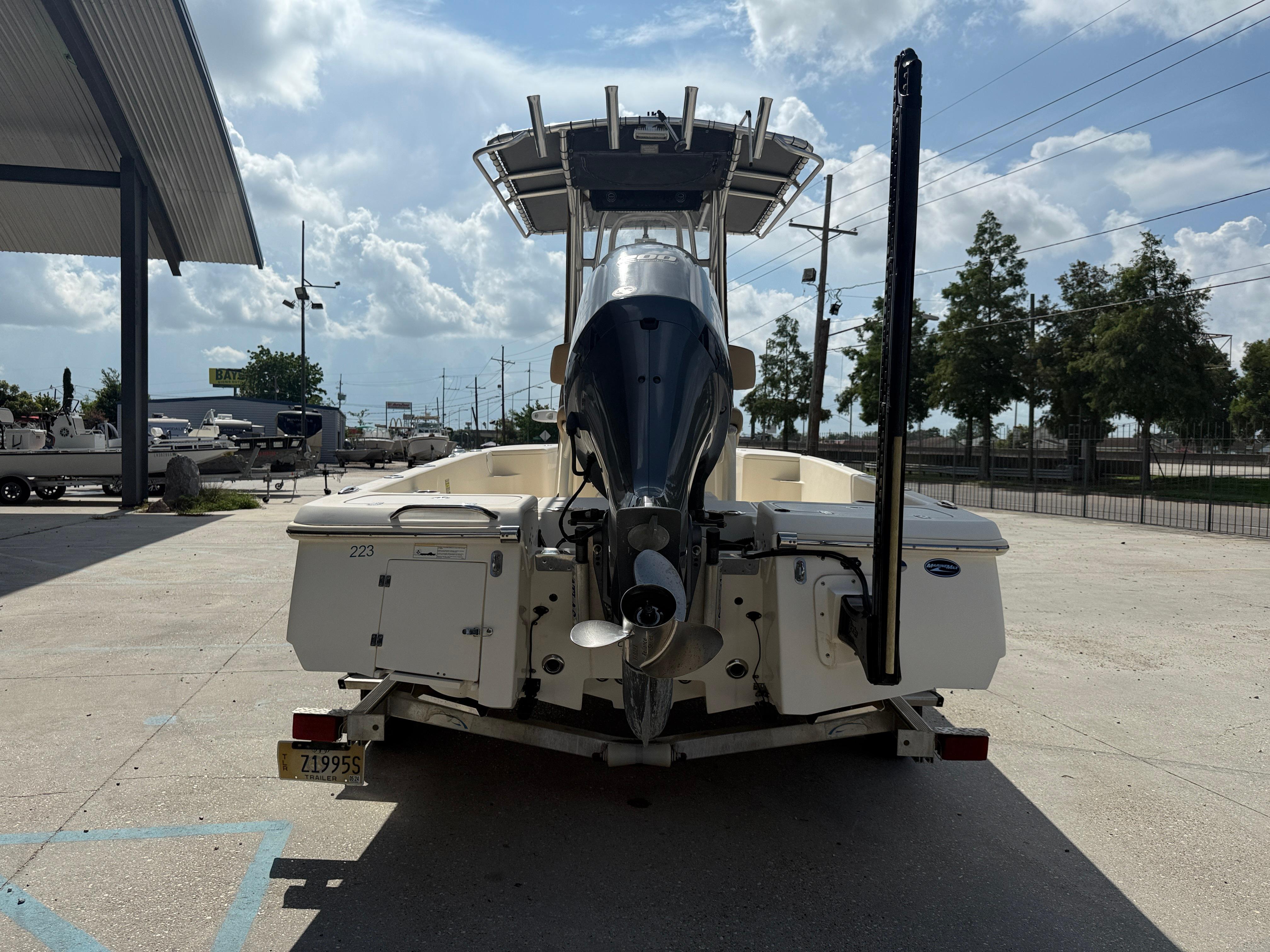 2014 Scout WINYAH BAY 221 boat, rear view, parked outdoors under a cloudy sky.