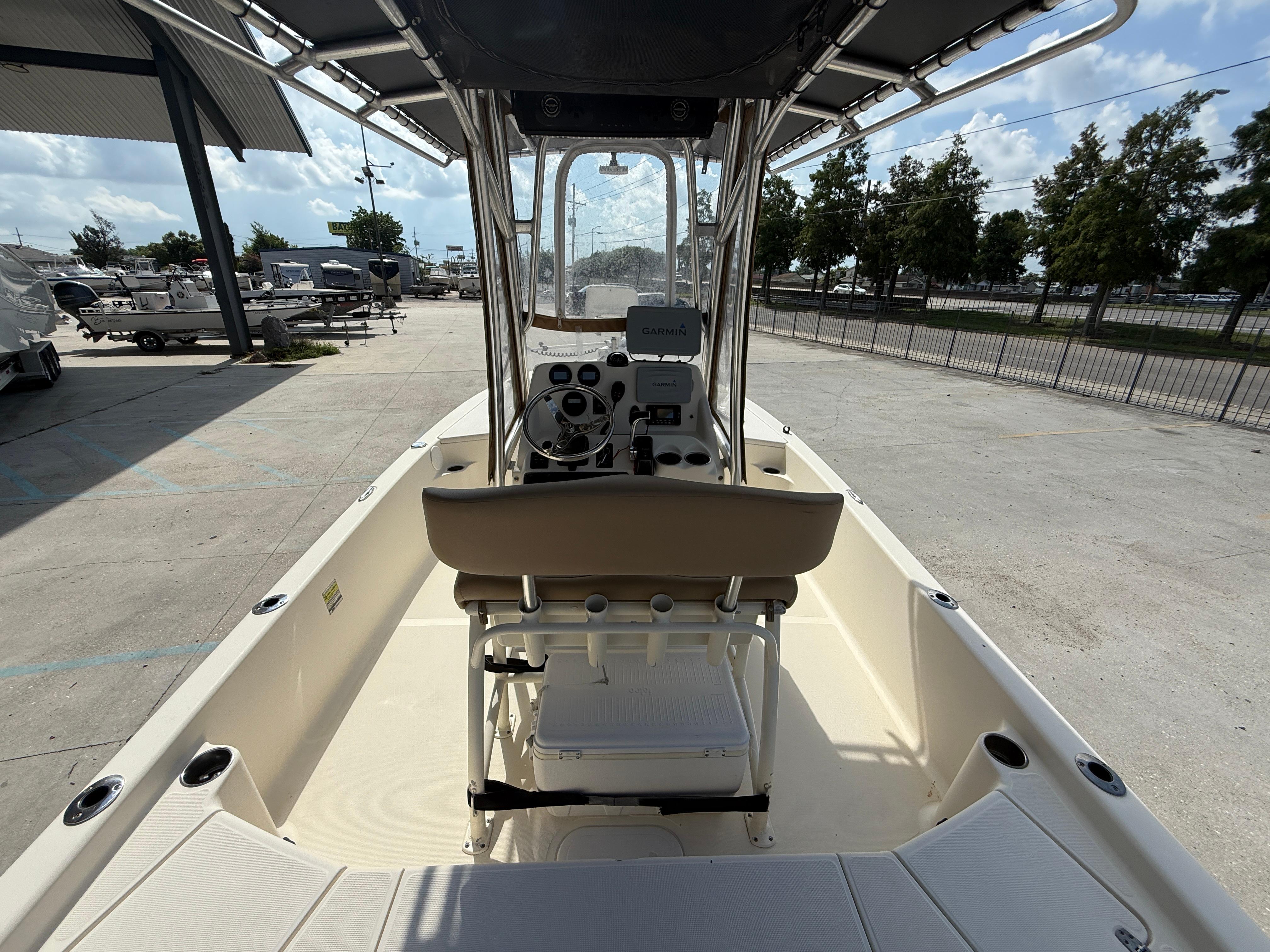 2014 Scout WINYAH BAY 221 boat interior with steering console and seating, parked outdoors.