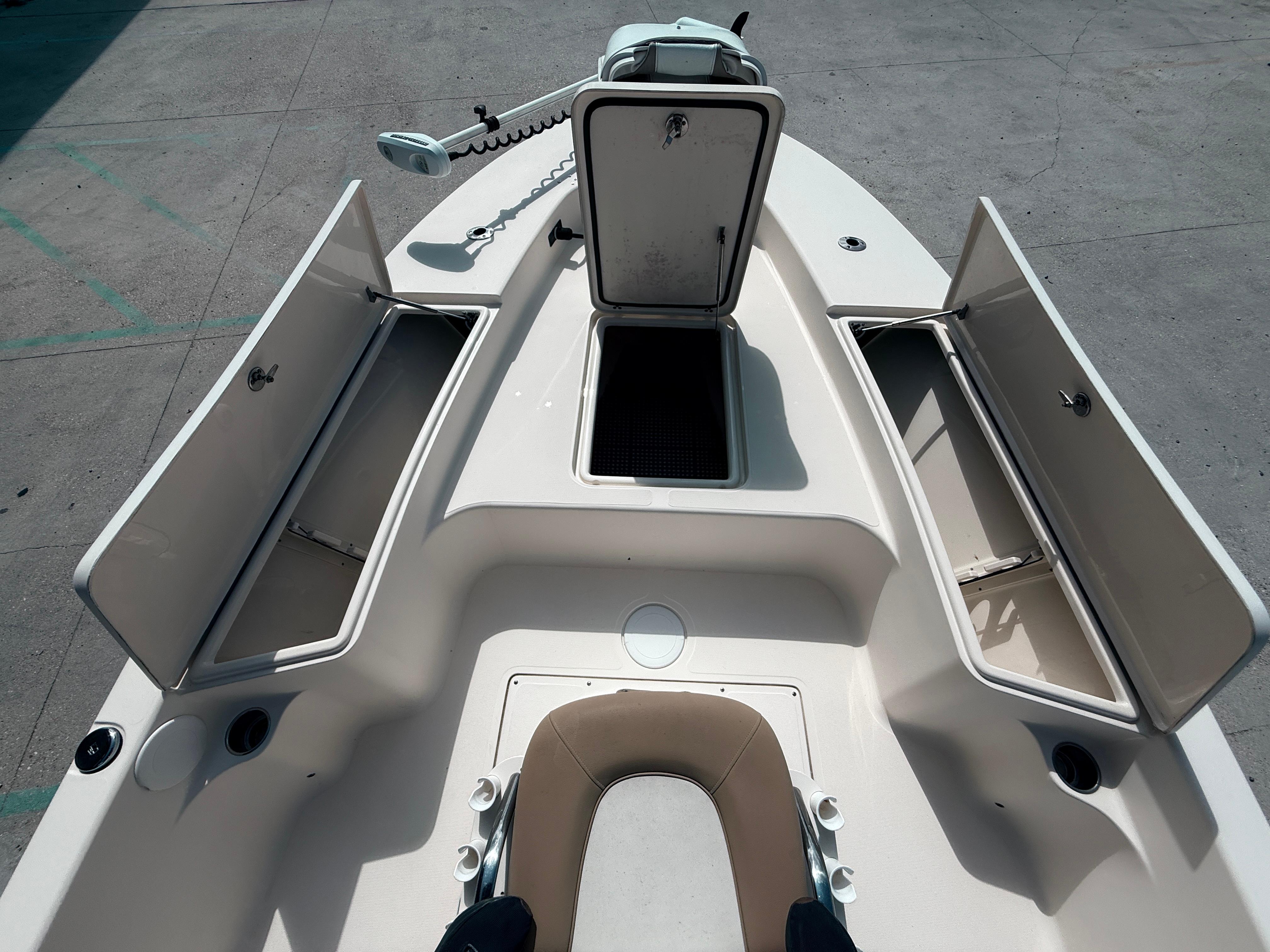 2014 Scout WINYAH BAY 221 boat with open storage compartments and seating.
