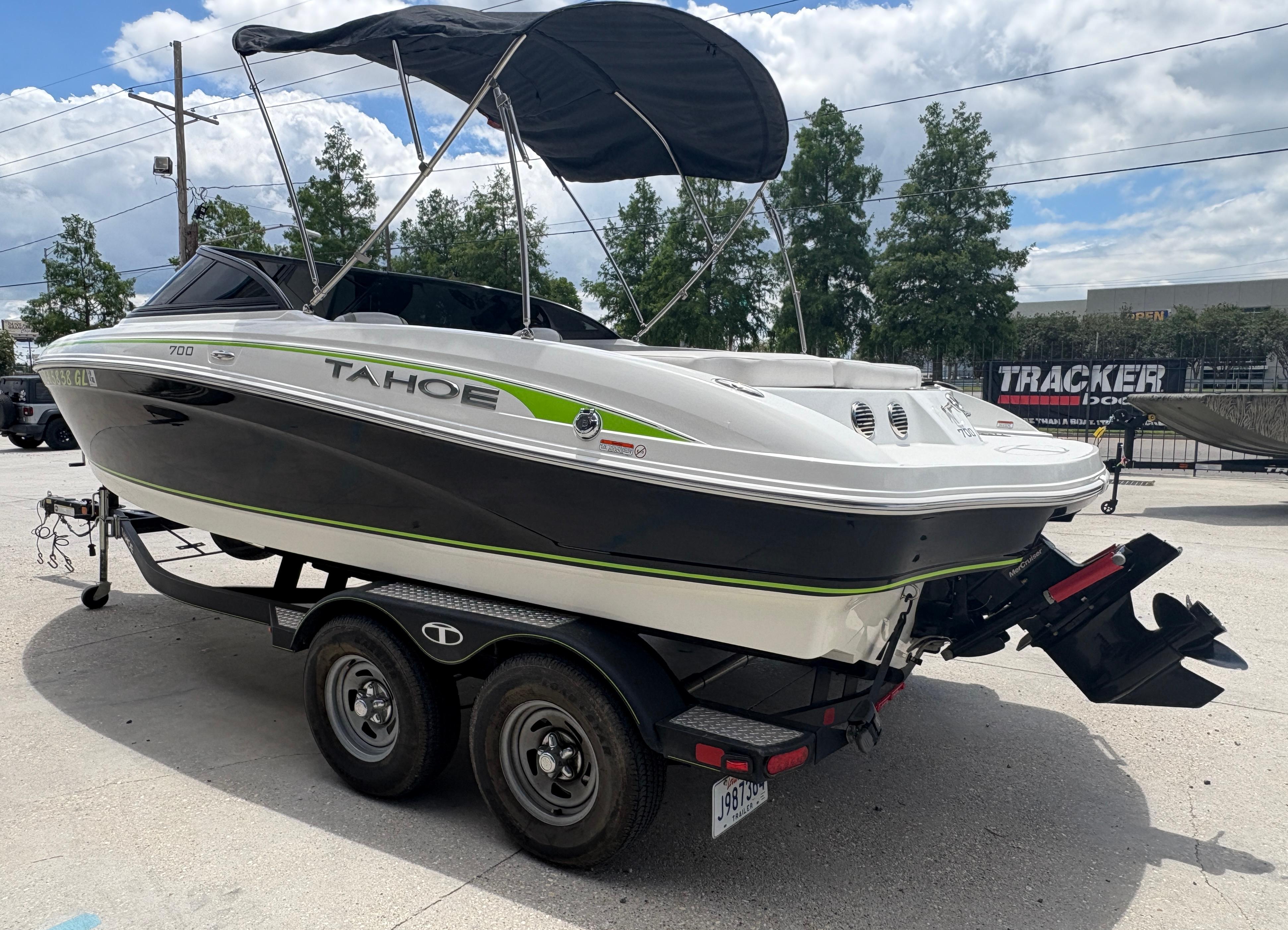 2019 Tahoe 700 boat on trailer, black and white design, outdoor setting.
