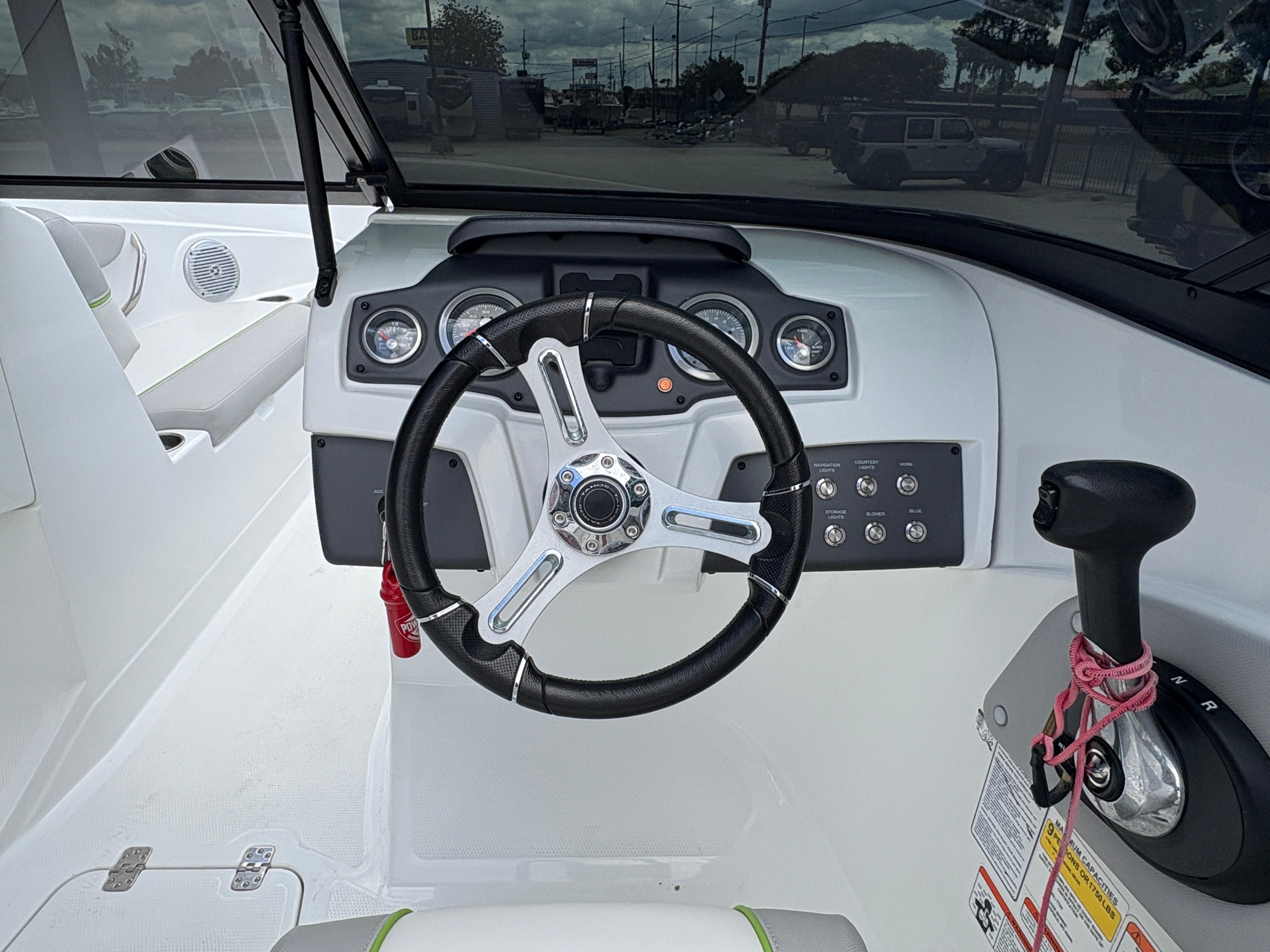 2019 Tahoe 700 boat dashboard with steering wheel and control panel.