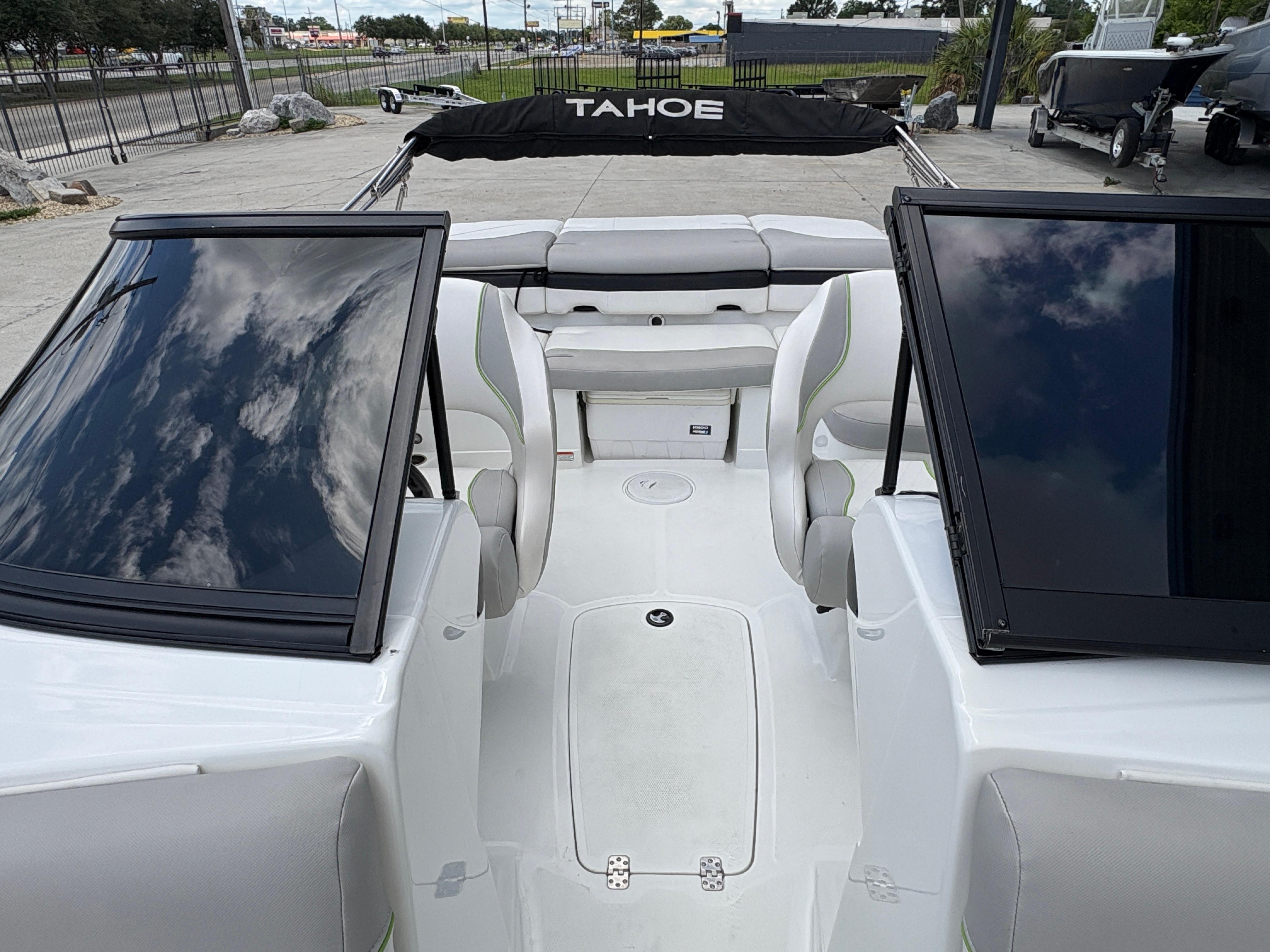 2019 Tahoe 700 boat interior with seating and windshield, parked outdoors.
