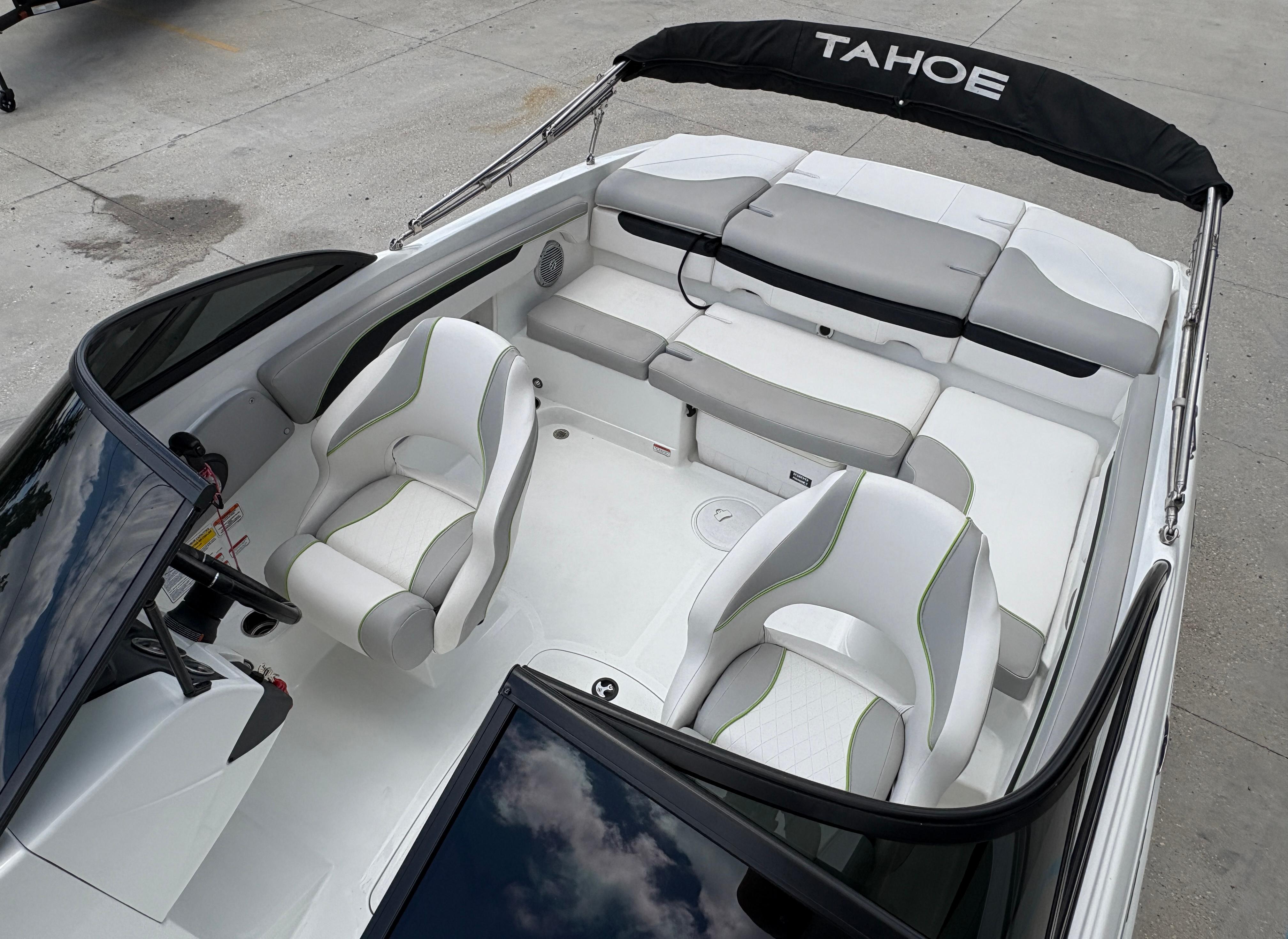 2019 Tahoe 700 boat interior with white and gray seating, black canopy, and modern design.